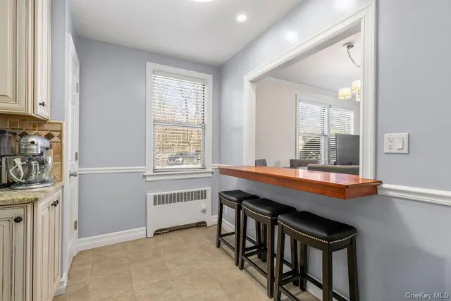 a room with pool table and windows