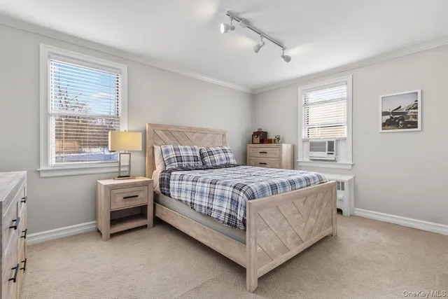 a bed sitting in a bedroom next to a window