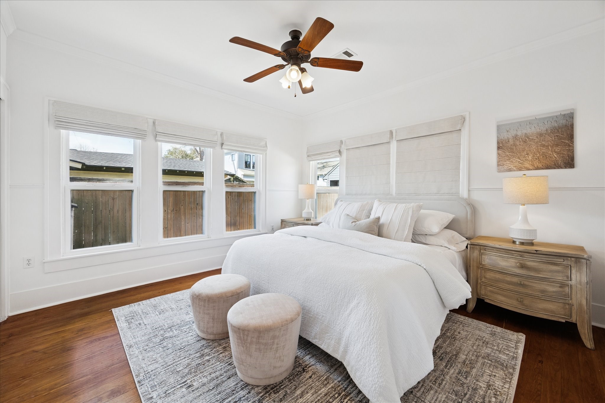 623 Pecore Street Houston, TX 77009 - Photo 17 of 34 Spacious primary bedroom with hardwood floors, high ceilings, and multiple windows bringing in soft natural light.