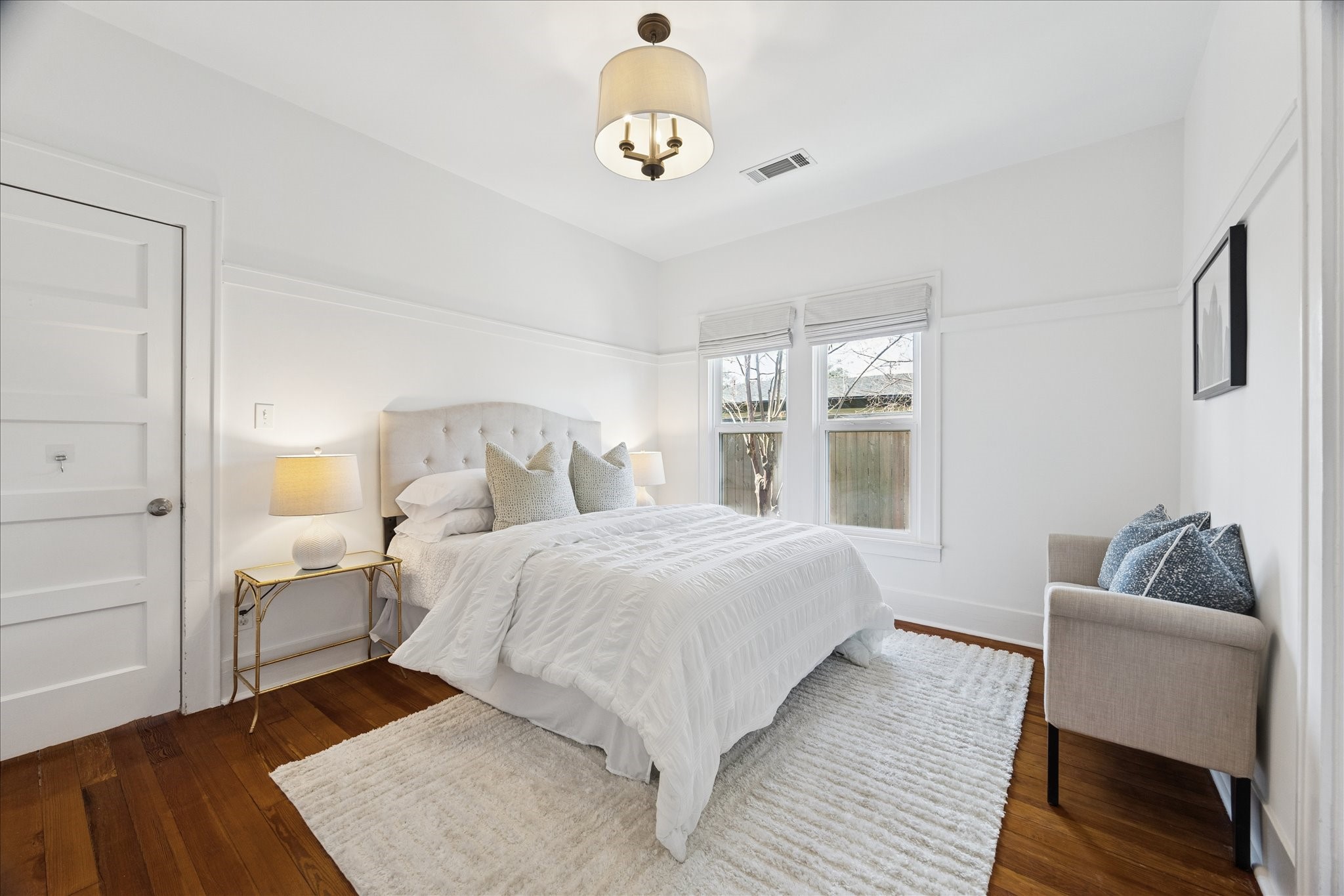 623 Pecore Street Houston, TX 77009 - Photo 21 of 34 Light-filled secondary bedroom with hardwood floors, high ceilings, and neutral finishes.