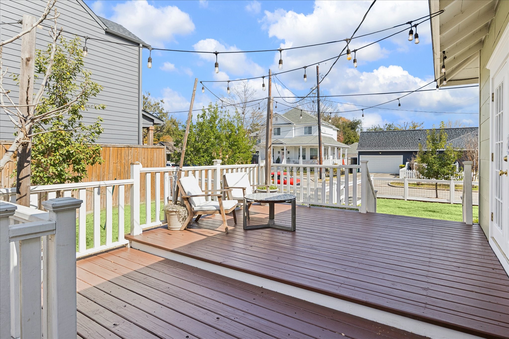623 Pecore Street Houston, TX 77009 - Photo 25 of 34 Inviting elevated deck with space for seating and dining, perfect for morning coffee or evening gatherings under the string lights.
