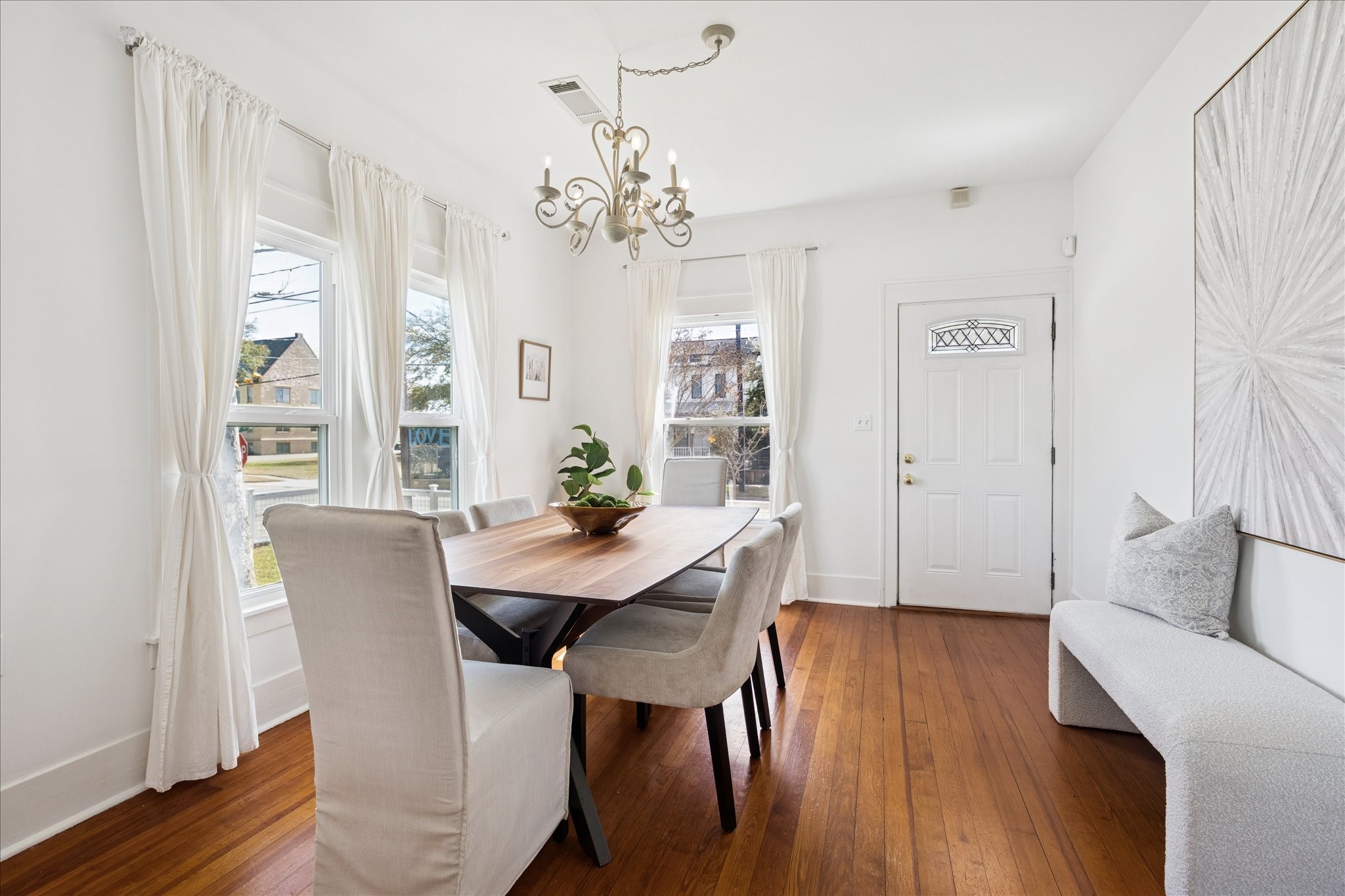623 Pecore Street Houston, TX 77009 - Photo 4 of 34 Light-filled dining room with tall ceilings, hardwood floors, and large windows overlooking the front yard.