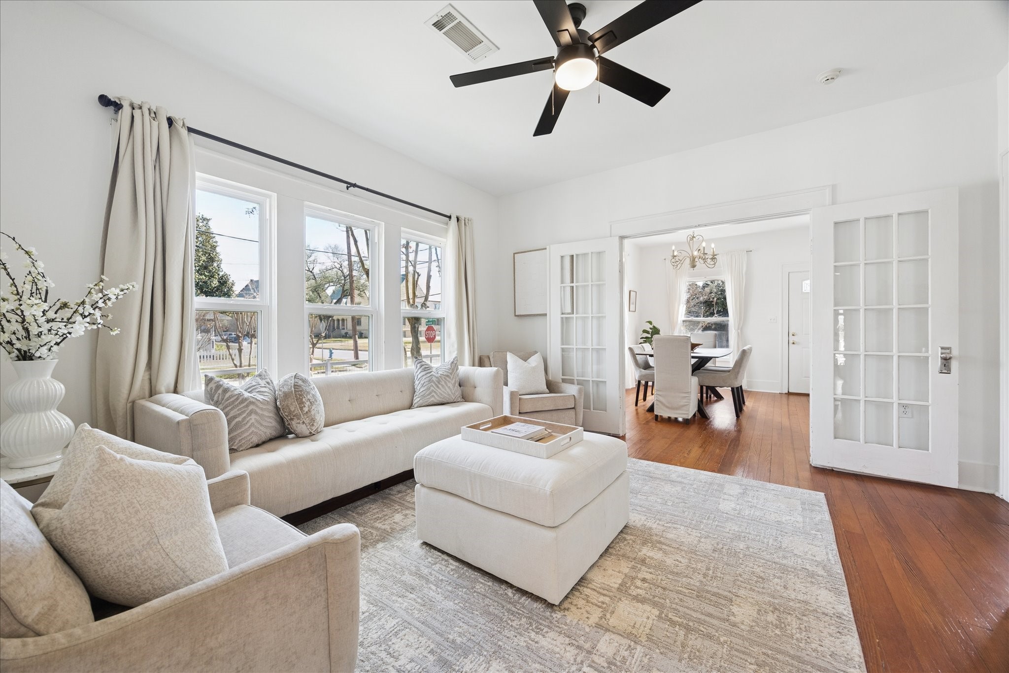 623 Pecore Street Houston, TX 77009 - Photo 7 of 34 Inviting living room featuring hardwood floors, abundant natural light, and views of the side yard.
