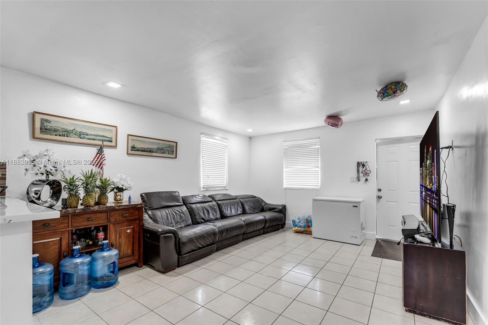 12750 Southwest 197th Avenue Miami, FL 33196 - Photo 26 of 60 a living room with furniture and a flat screen tv