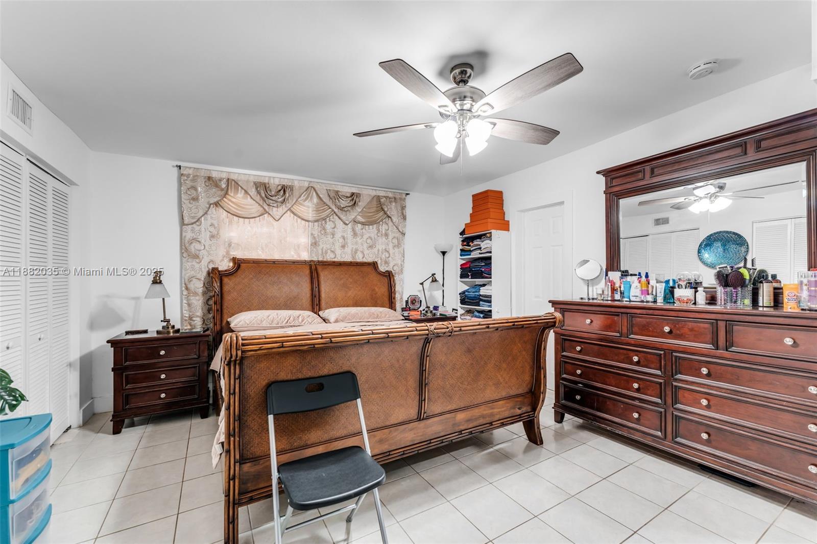 12750 Southwest 197th Avenue Miami, FL 33196 - Photo 33 of 60 a bed room with a bed and a chandelier