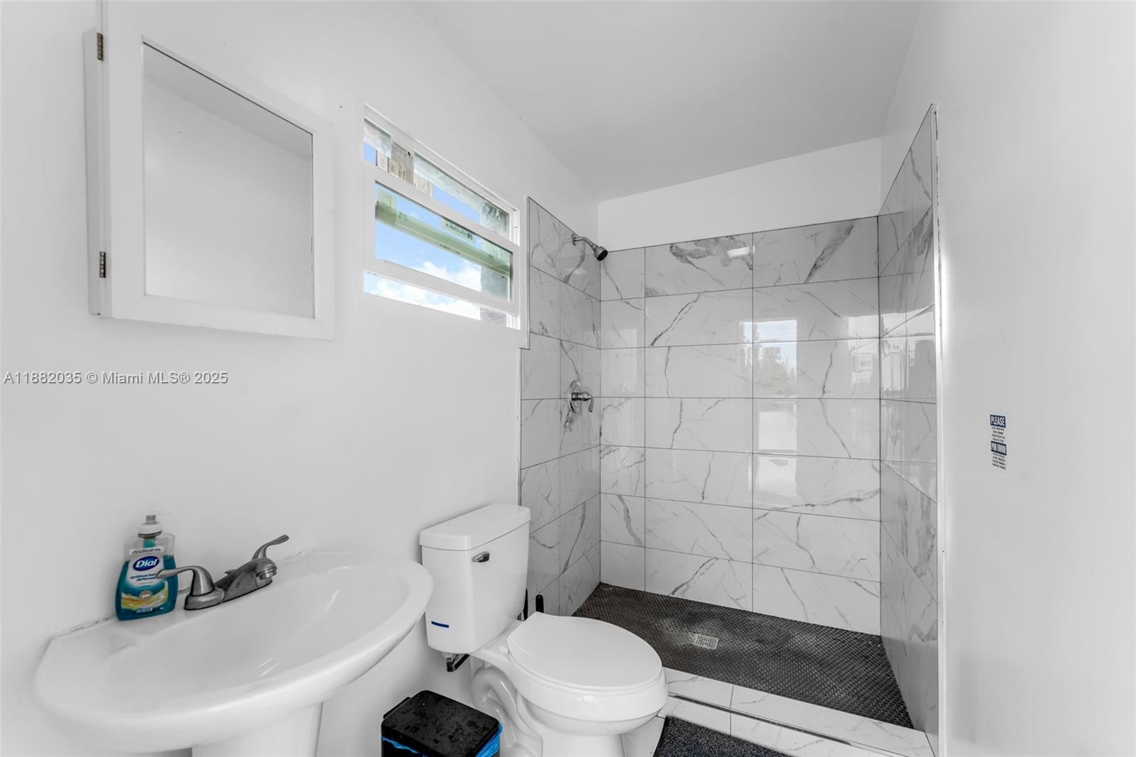 12750 Southwest 197th Avenue Miami, FL 33196 - Photo 45 of 60 a white toilet sitting next to a bathroom sink