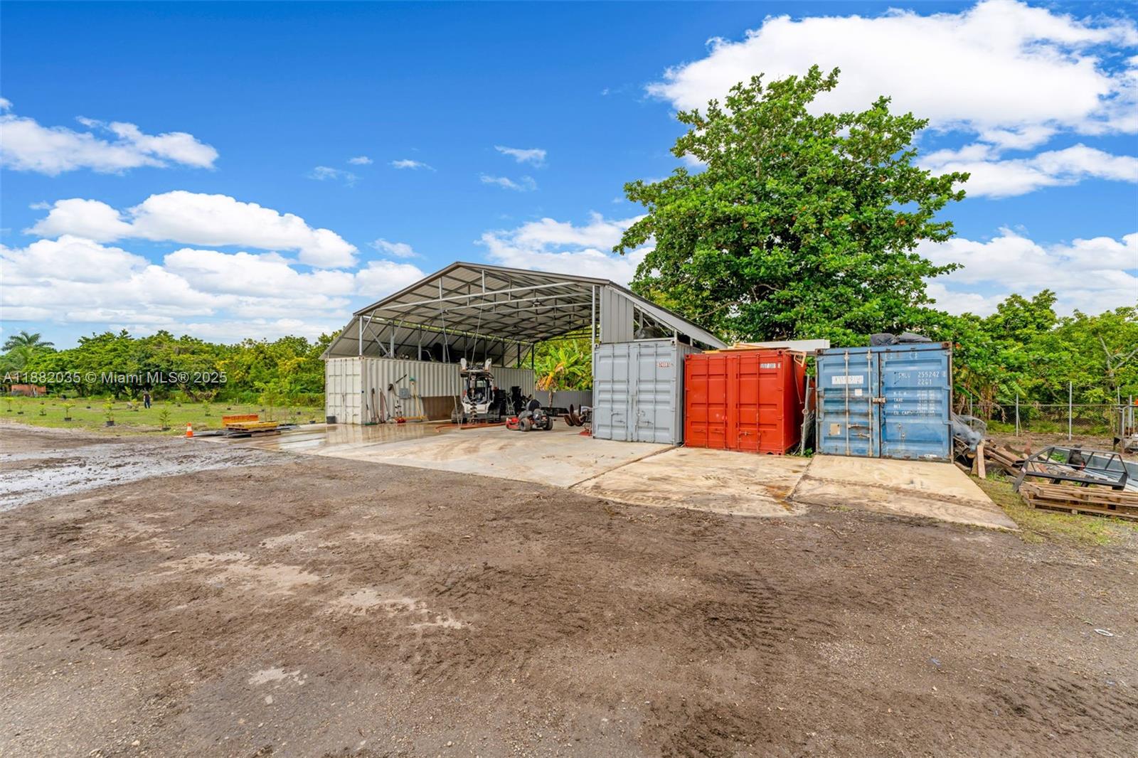 12750 Southwest 197th Avenue Miami, FL 33196 - Photo 46 of 60 a view of a house with a yard and a garage
