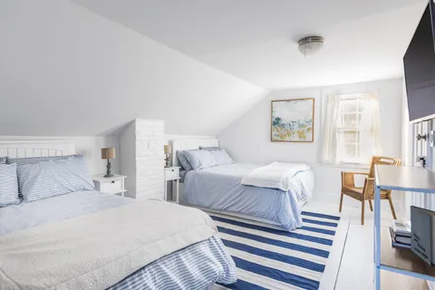 a bedroom with two beds and a table