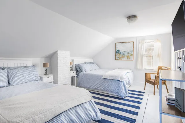 a bedroom with two beds and a table