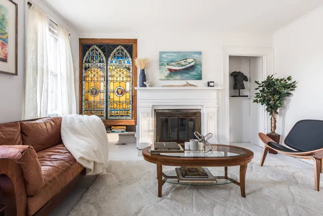 a living room with furniture a table and a fireplace