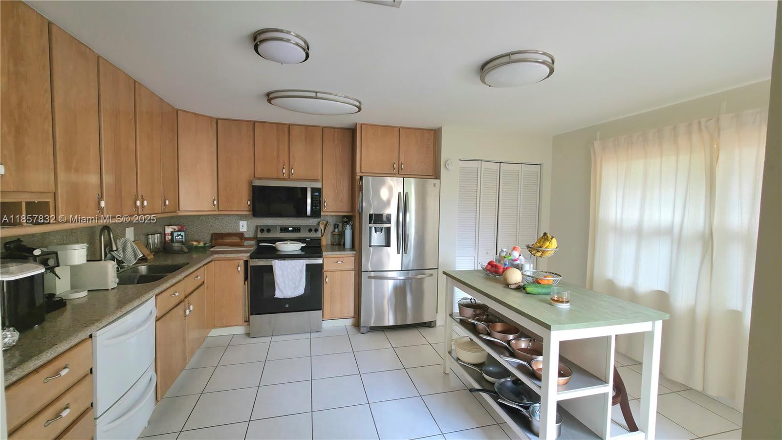 8906 Southwest 113th Pl Circle East Miami, FL 33176 - Photo 1 of 15 a kitchen with a sink stainless steel appliances cabinets and a window