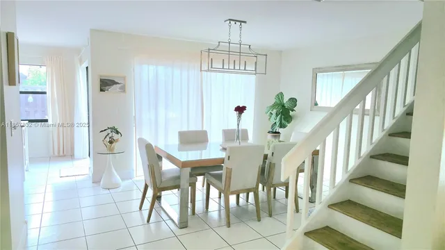 a view of a hallway with entryway windows and kitchen view