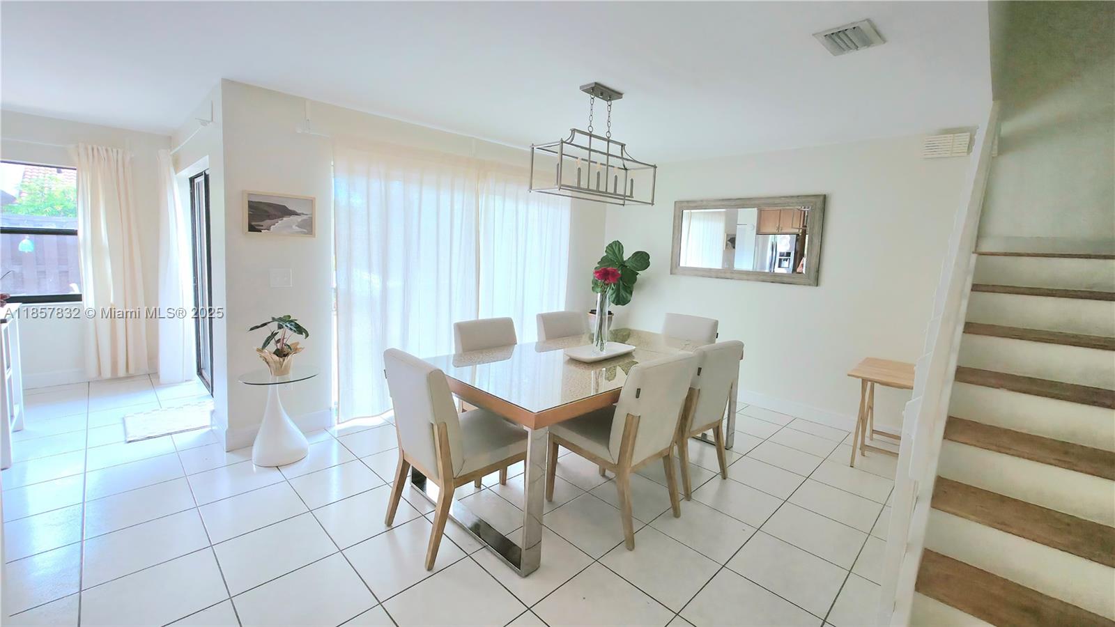 8906 Southwest 113th Pl Circle East Miami, FL 33176 - Photo 4 of 15 a view of a dining room with furniture and chandelier