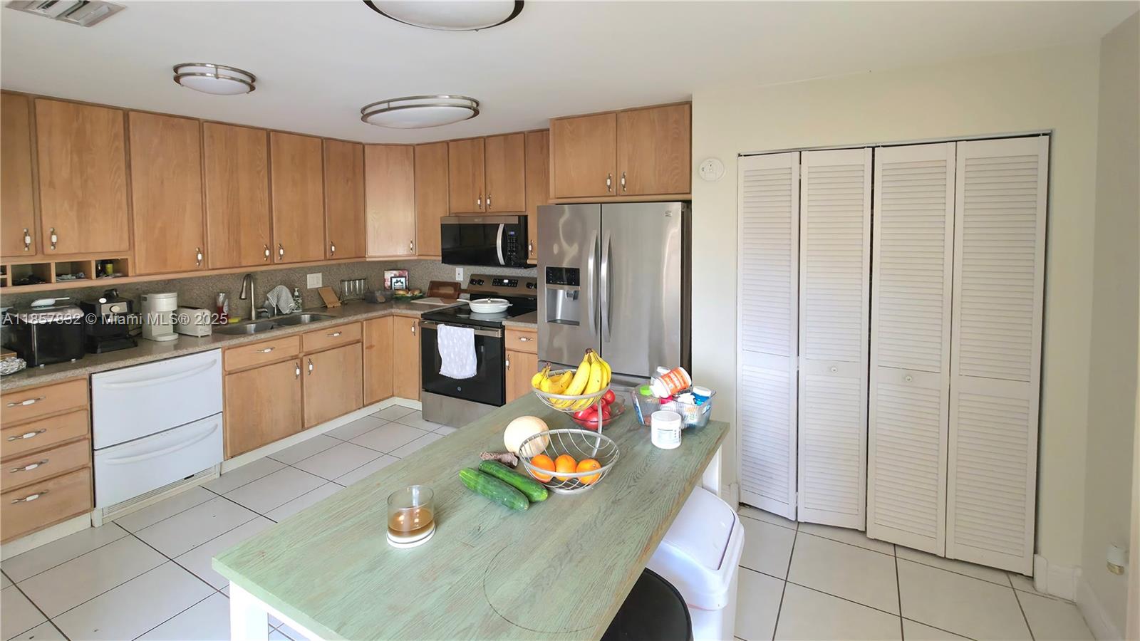 8906 Southwest 113th Pl Circle East Miami, FL 33176 - Photo 5 of 15 a kitchen with stainless steel appliances granite countertop a sink refrigerator and cabinets