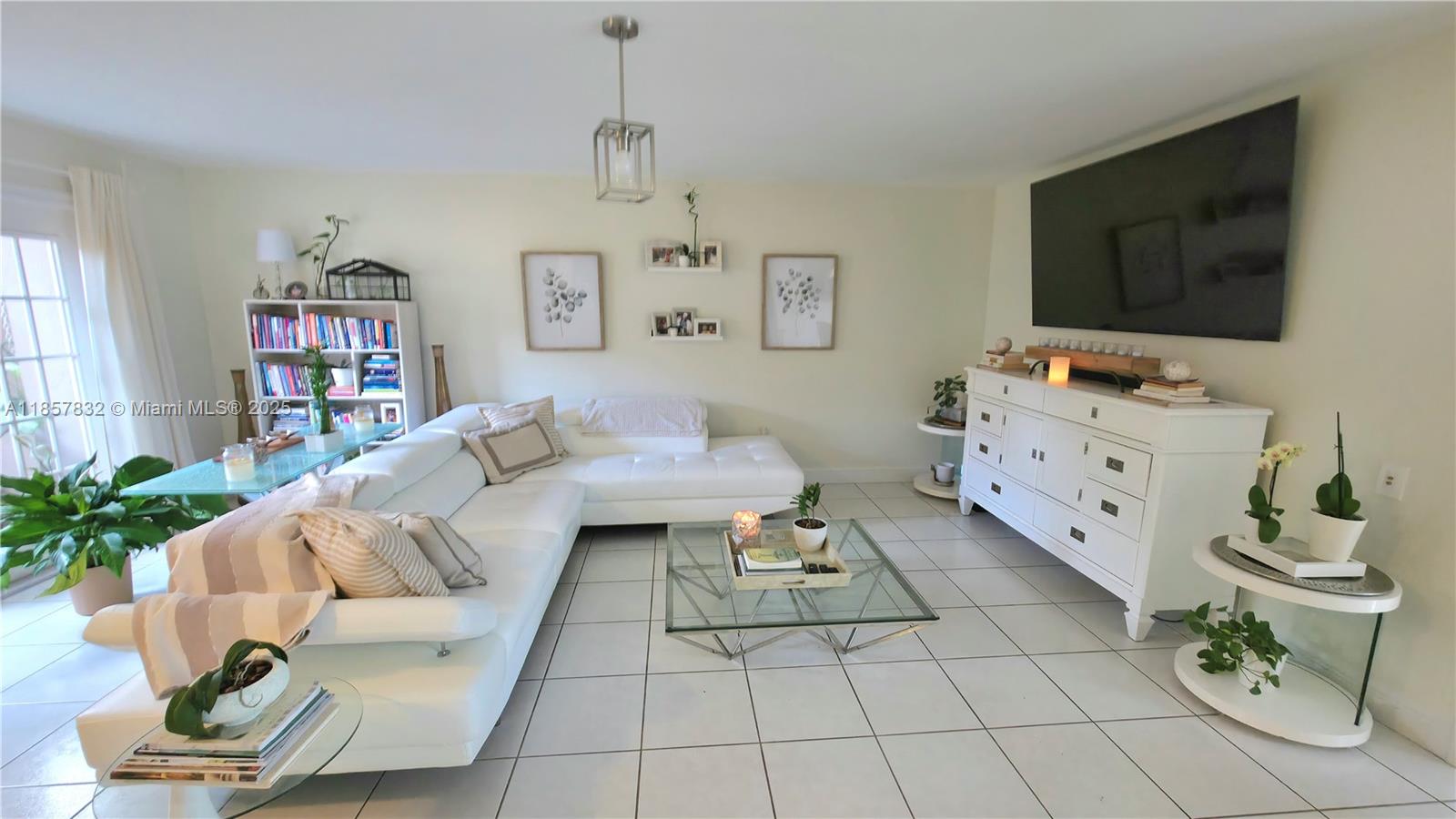 8906 Southwest 113th Pl Circle East Miami, FL 33176 - Photo 8 of 15 a living room with furniture and a flat screen tv