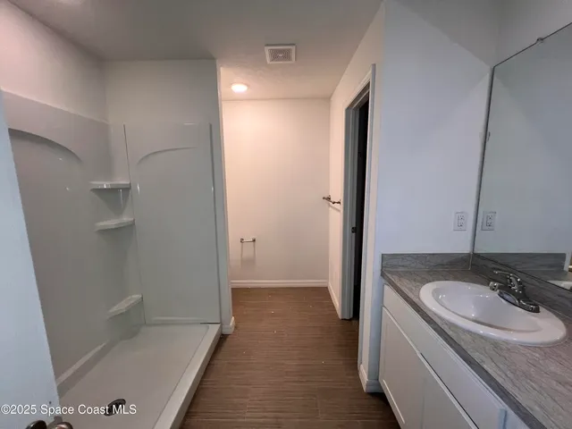 a bathroom with a sink and a shower