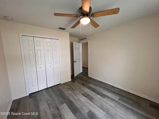 a view of an empty room with a fan
