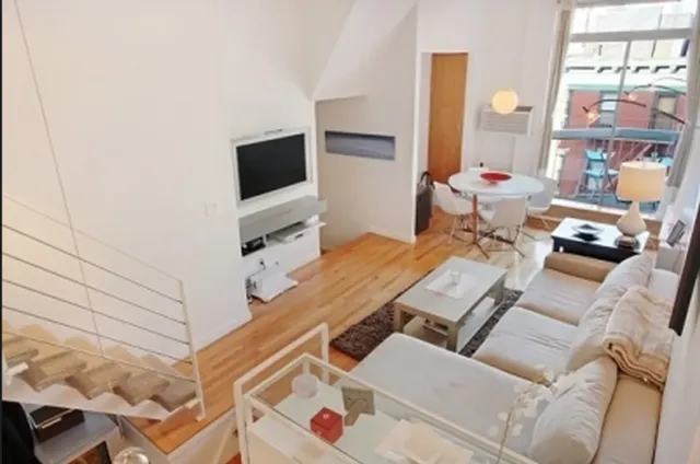 a terrace with outdoor seating and a flat screen tv