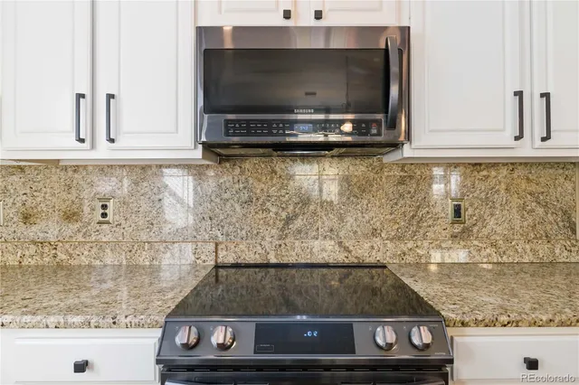 a living room with furniture a flat screen tv and wooden floor
