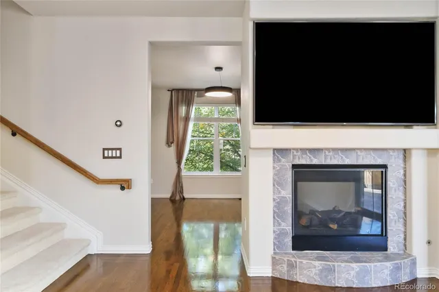 an empty room with wooden floor and fireplace