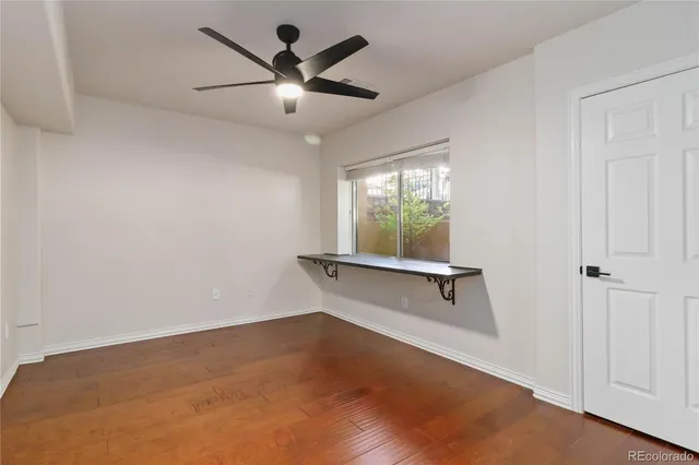 a view of a hallway with wooden floor and entryway