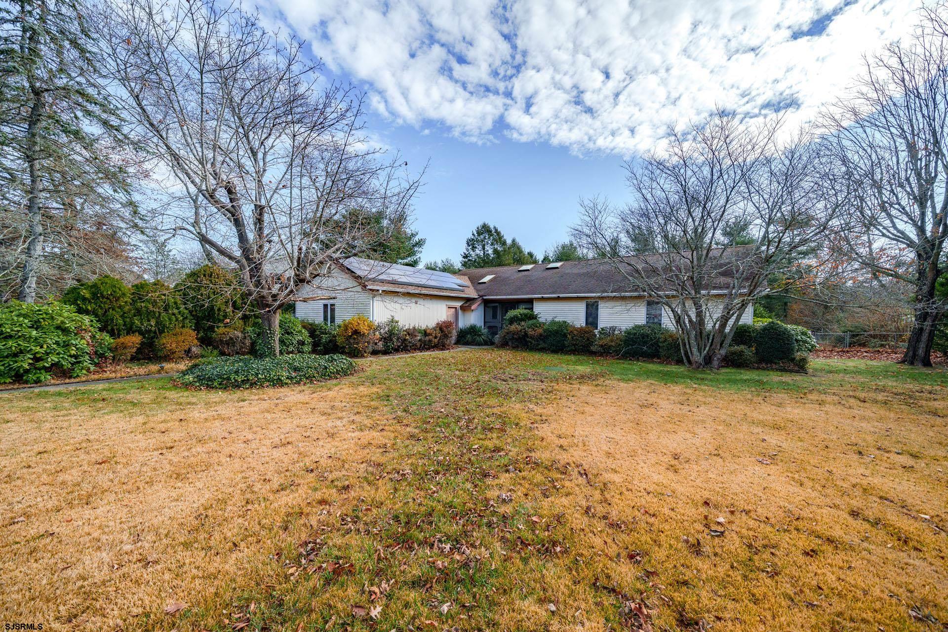a front view of house with a yard and trees