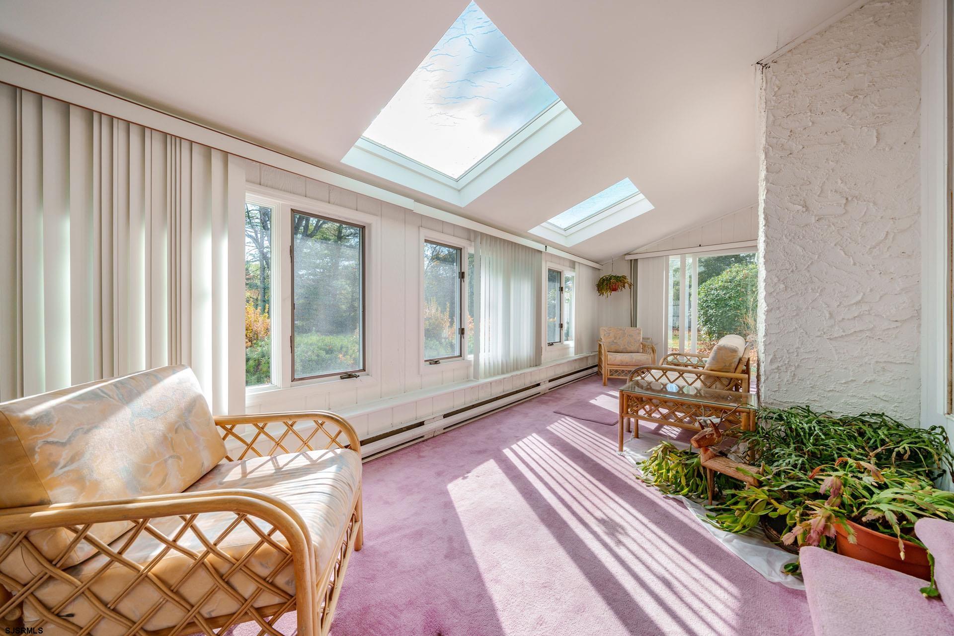 601 2nd Avenue Marmora, NJ 08223 - Photo 11 of 31 a living room with furniture and a floor to ceiling window