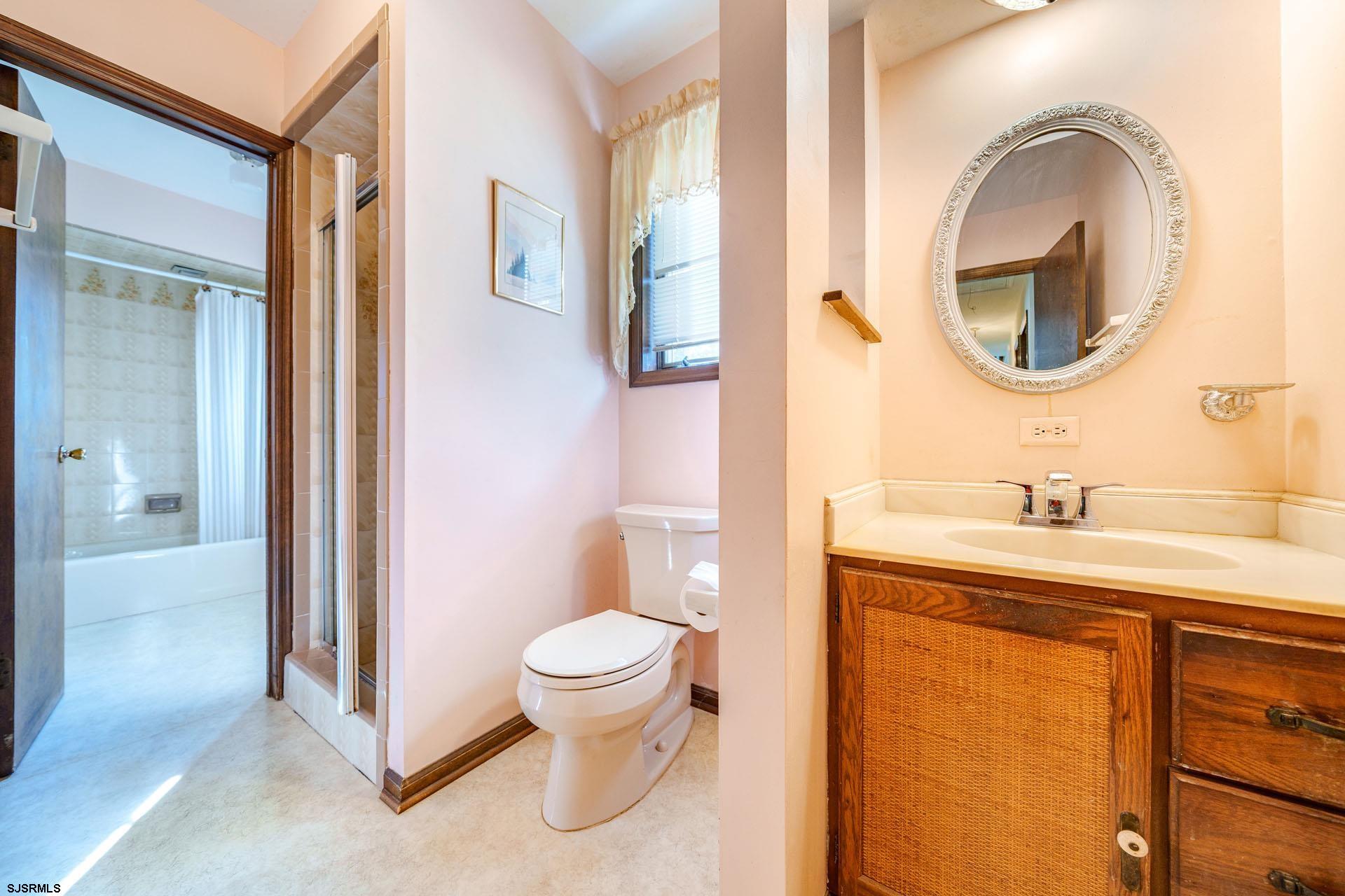601 2nd Avenue Marmora, NJ 08223 - Photo 17 of 31 a bathroom with a granite countertop toilet sink and mirror