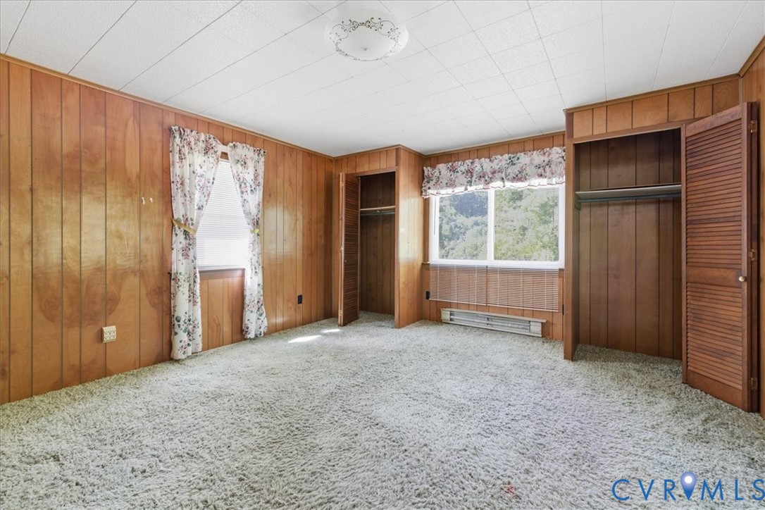 8100 Sandy Ridge Road Hopewell, VA 23860 - Photo 19 of 36 Wood paneling walls, textured ceiling, and light-c
