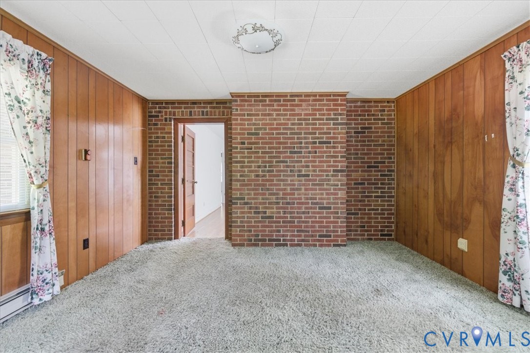 8100 Sandy Ridge Road Hopewell, VA 23860 - Photo 20 of 36 Room featuring brick and wood-panel walls, light-c