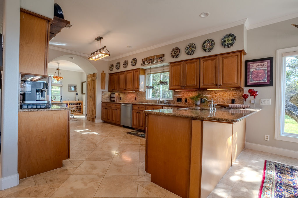 1950 Estrellita Ranch Road Canyon Lake, TX 78133 - Photo 18 of 34 a kitchen with stainless steel appliances granite countertop a refrigerator and a stove top oven