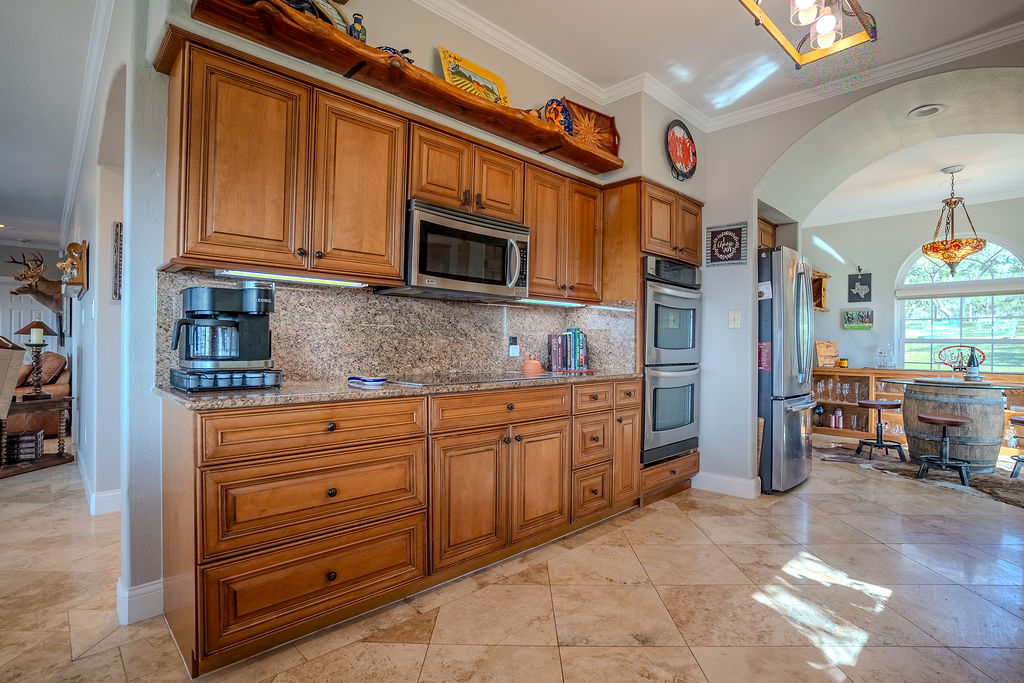 1950 Estrellita Ranch Road Canyon Lake, TX 78133 - Photo 20 of 34 a kitchen with stainless steel appliances granite countertop a refrigerator and microwave