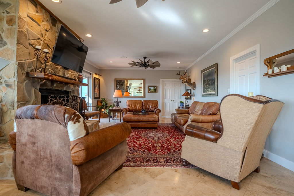 1950 Estrellita Ranch Road Canyon Lake, TX 78133 - Photo 22 of 34 a living room with furniture and a fireplace