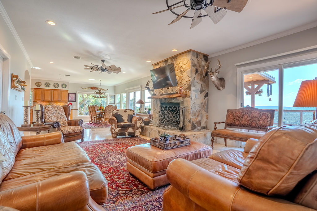 1950 Estrellita Ranch Road Canyon Lake, TX 78133 - Photo 23 of 34 a living room with furniture fireplace and a large window