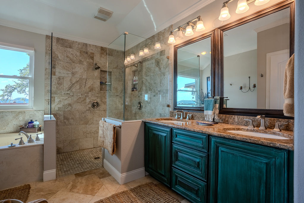1950 Estrellita Ranch Road Canyon Lake, TX 78133 - Photo 24 of 34 a bathroom with a double vanity sink mirror and shower