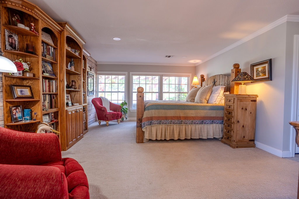 1950 Estrellita Ranch Road Canyon Lake, TX 78133 - Photo 26 of 34 a bedroom with furniture and a book shelf