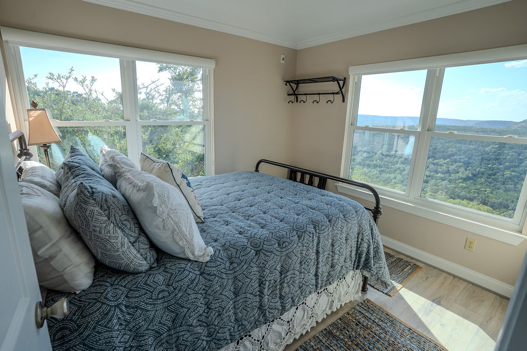 1950 Estrellita Ranch Road Canyon Lake, TX 78133 - Photo 29 of 34 a bed sitting in a bedroom next to a window