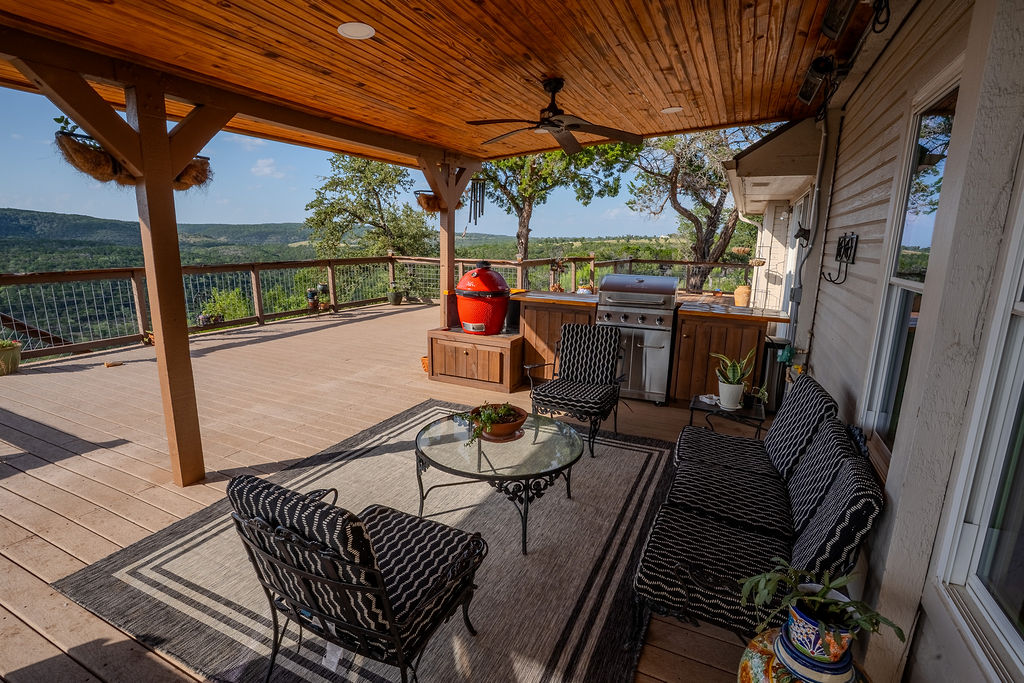 1950 Estrellita Ranch Road Canyon Lake, TX 78133 - Photo 6 of 34 a view of a patio with table and chairs potted plants with wooden floor and fence