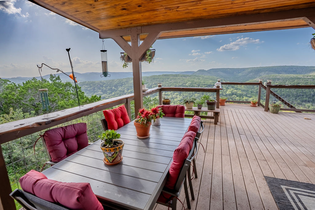 1950 Estrellita Ranch Road Canyon Lake, TX 78133 - Photo 7 of 34 a view of deck with table and chairs potted plants with wooden floor