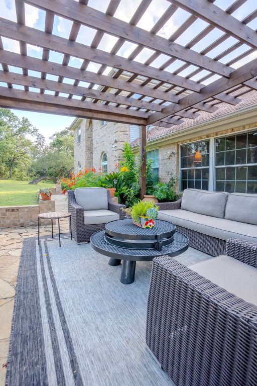 1950 Estrellita Ranch Road Canyon Lake, TX 78133 - Photo 10 of 34 a living room with patio furniture and a large window