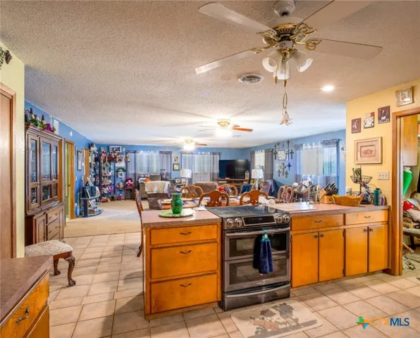 a view of a kitchen and that has a lot of stuff in it