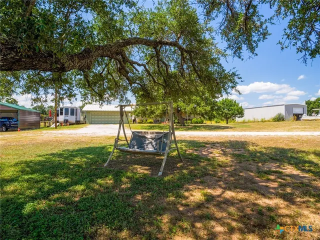 a front view of a house with a big yard
