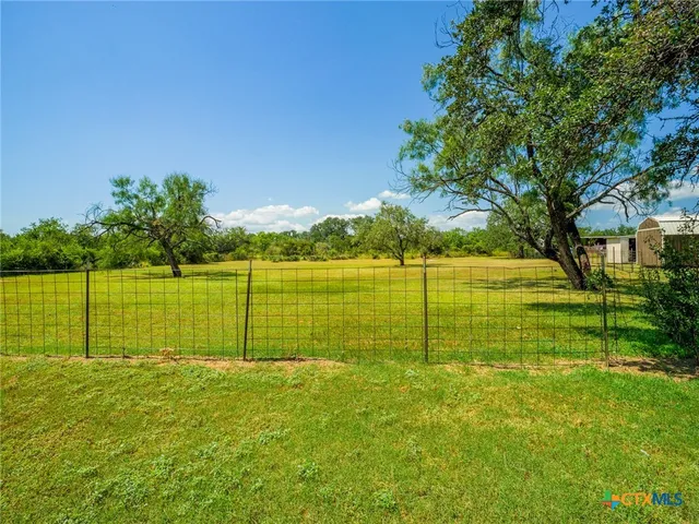 a view of a house with a yard and a porch