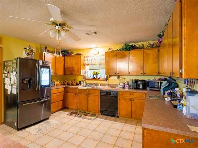 a kitchen with stainless steel appliances a stove cabinets and a refrigerator