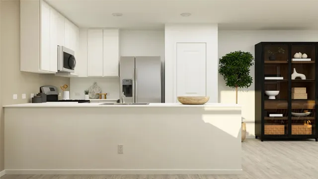 a kitchen with stainless steel appliances a refrigerator and a sink