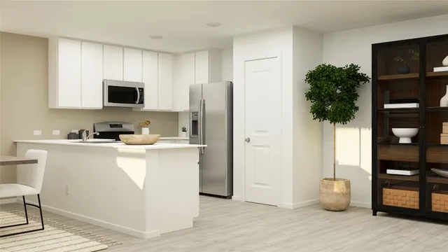 a kitchen with stainless steel appliances a refrigerator sink and microwave