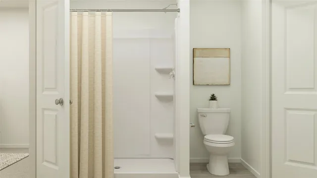 a white toilet sitting next to a bathroom sink