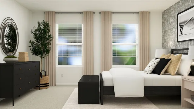 a bedroom with a large bed and a potted plant