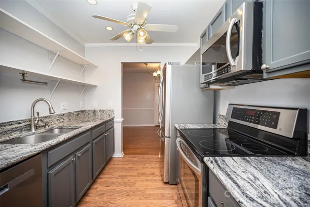 a kitchen with stainless steel appliances granite countertop a sink and stove