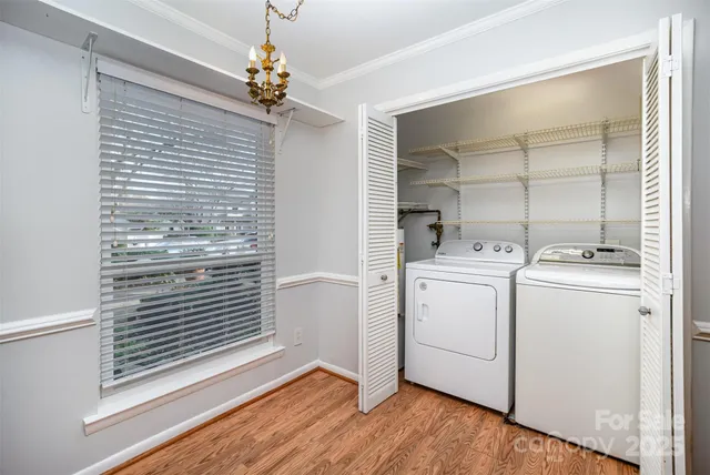 a view of washer and dryer with bathroom in the background
